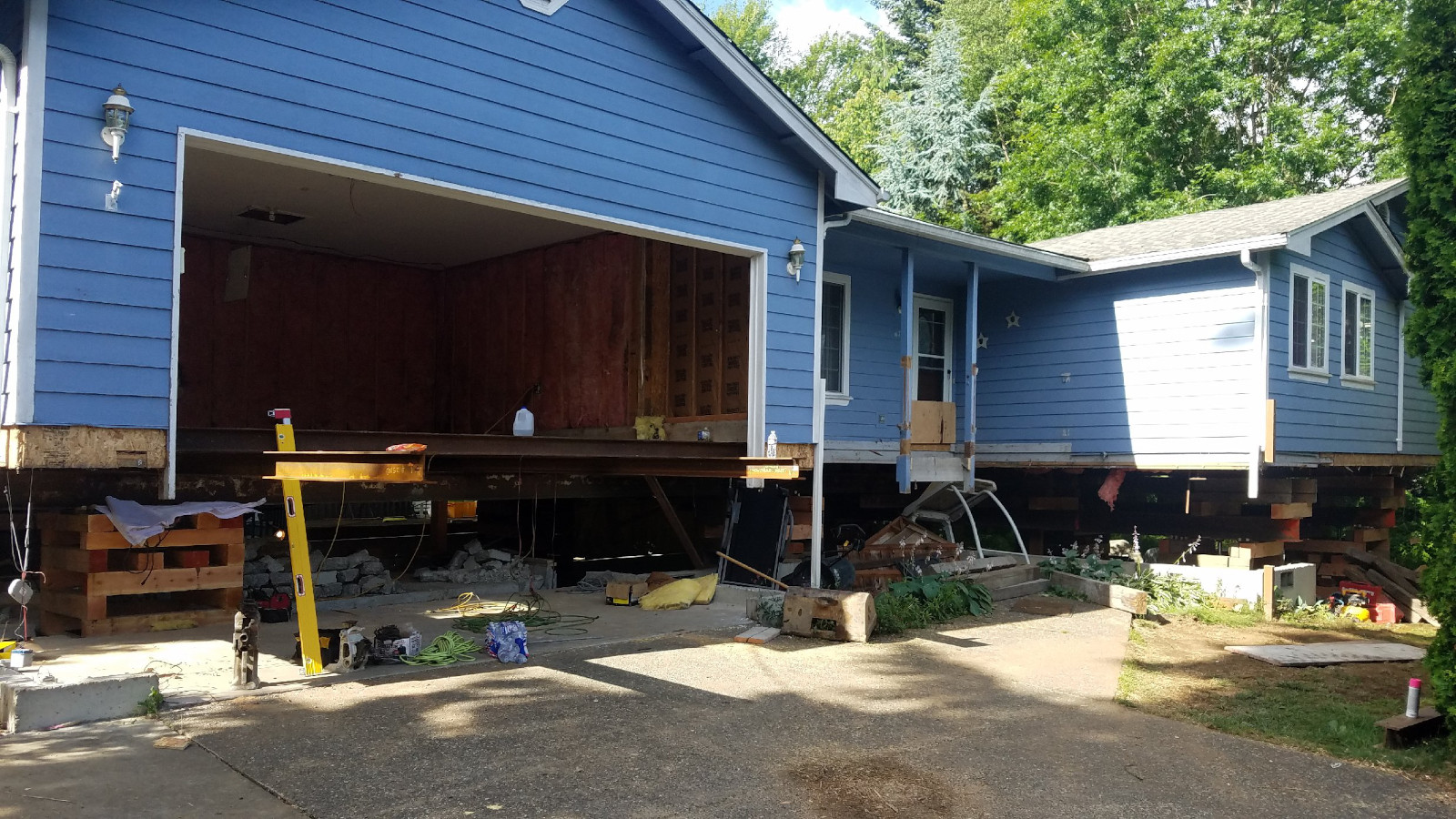 Single-story Seattle rambler raised on cribbing for a full house lift